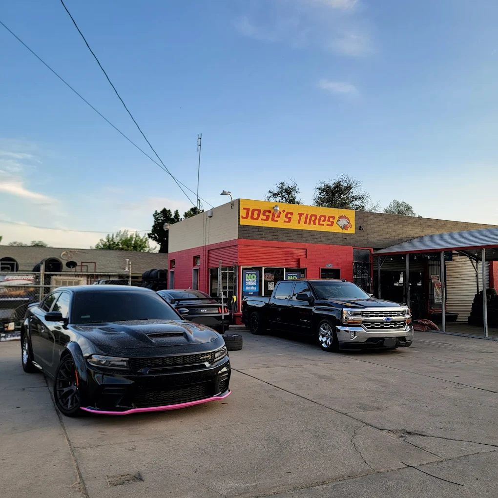 Lowered Chevy truck and Dodge Charger parked in front of Jose's Tires