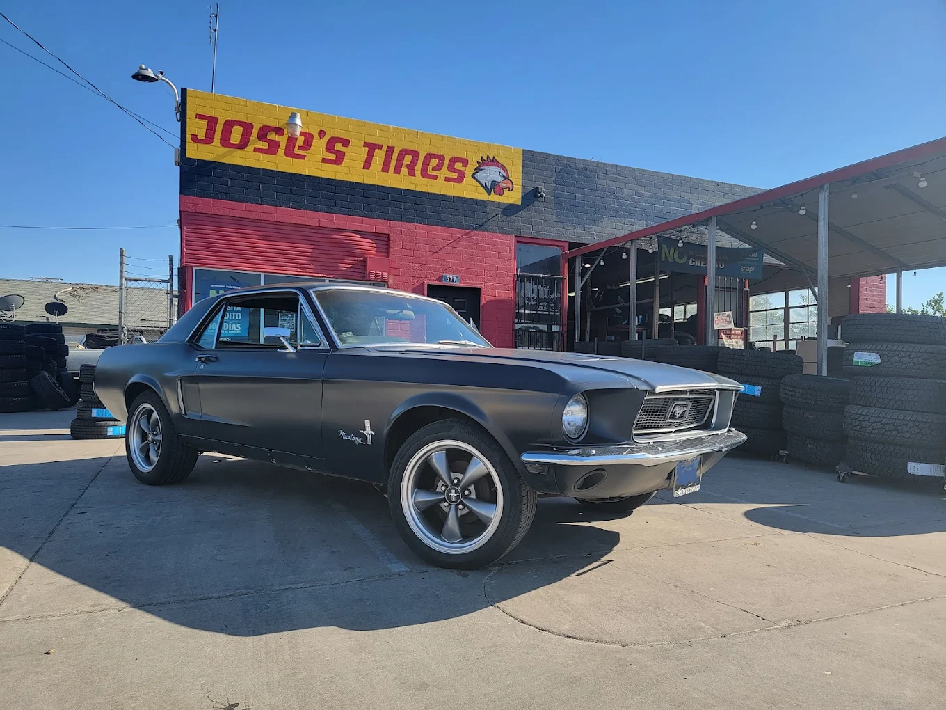 Classic Ford Mustang on custom wheels outside Jose's Tires