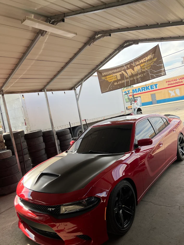 Red widebody Dodge Charger Hellcat with custom black wheels at Jose's Tires