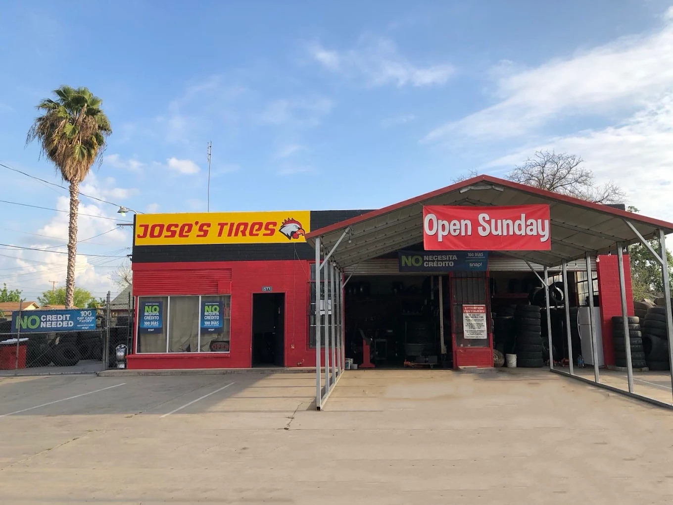 Jose's Tires shop exterior with covered service bays, open Sunday